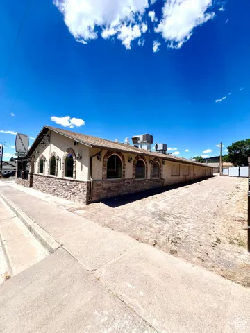 View of front of home with stone siding and stucco siding