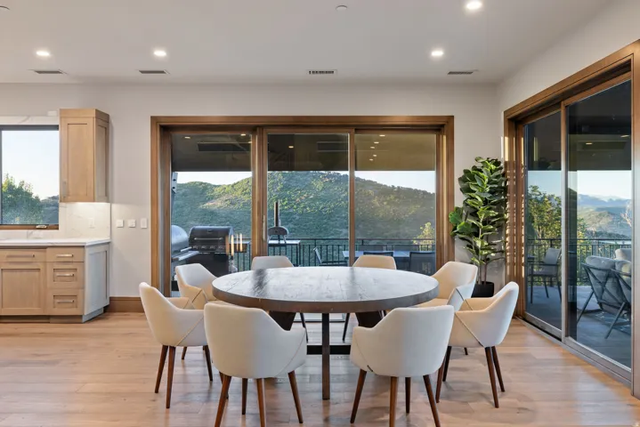 Dining room with light wood-style flooring, a mountain view, and recessed lighting