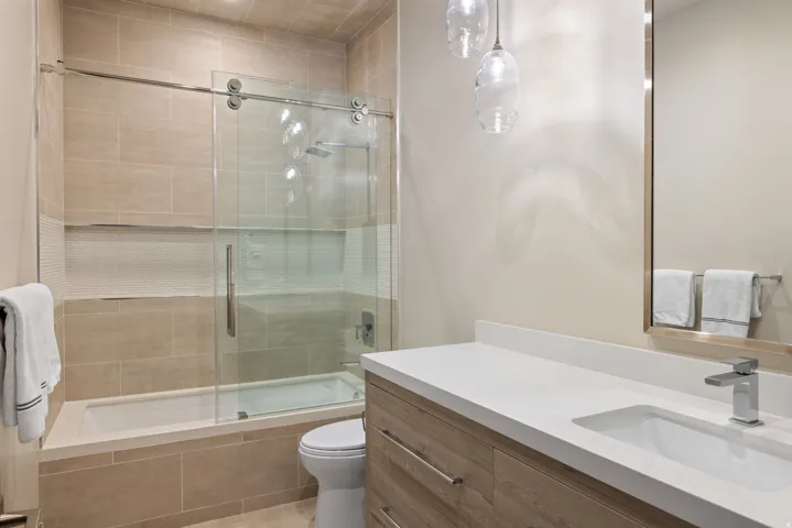 Bathroom with vanity and tiled shower / bath