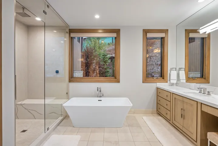 Bathroom featuring a tile shower, a freestanding bath, vanity, light tile patterned floors, and recessed lighting