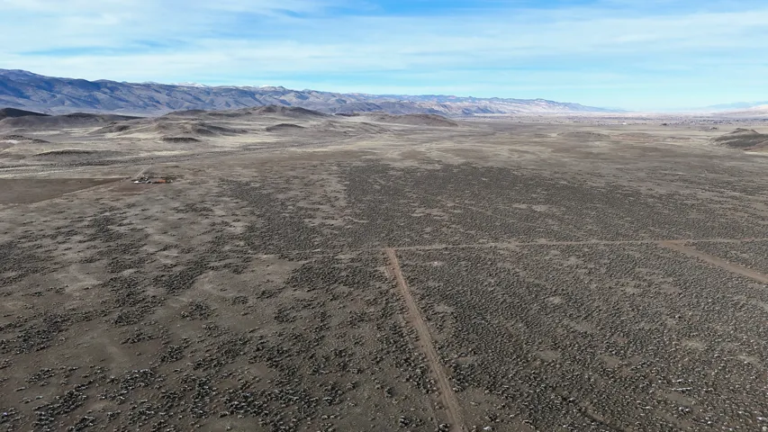 Overview of rural landscape with a mountainous background and a desert landscape