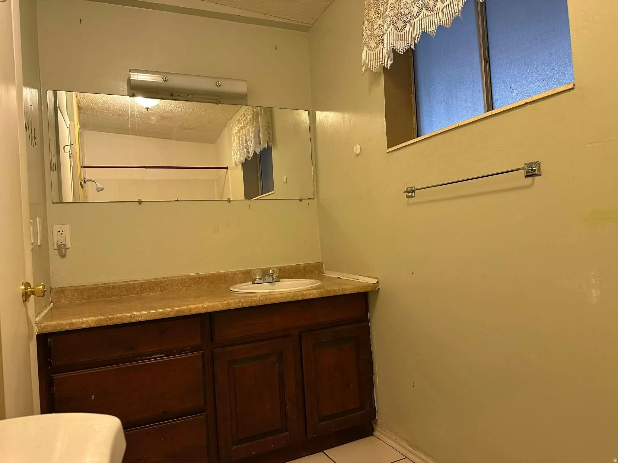 Bathroom with vanity and light tile patterned flooring