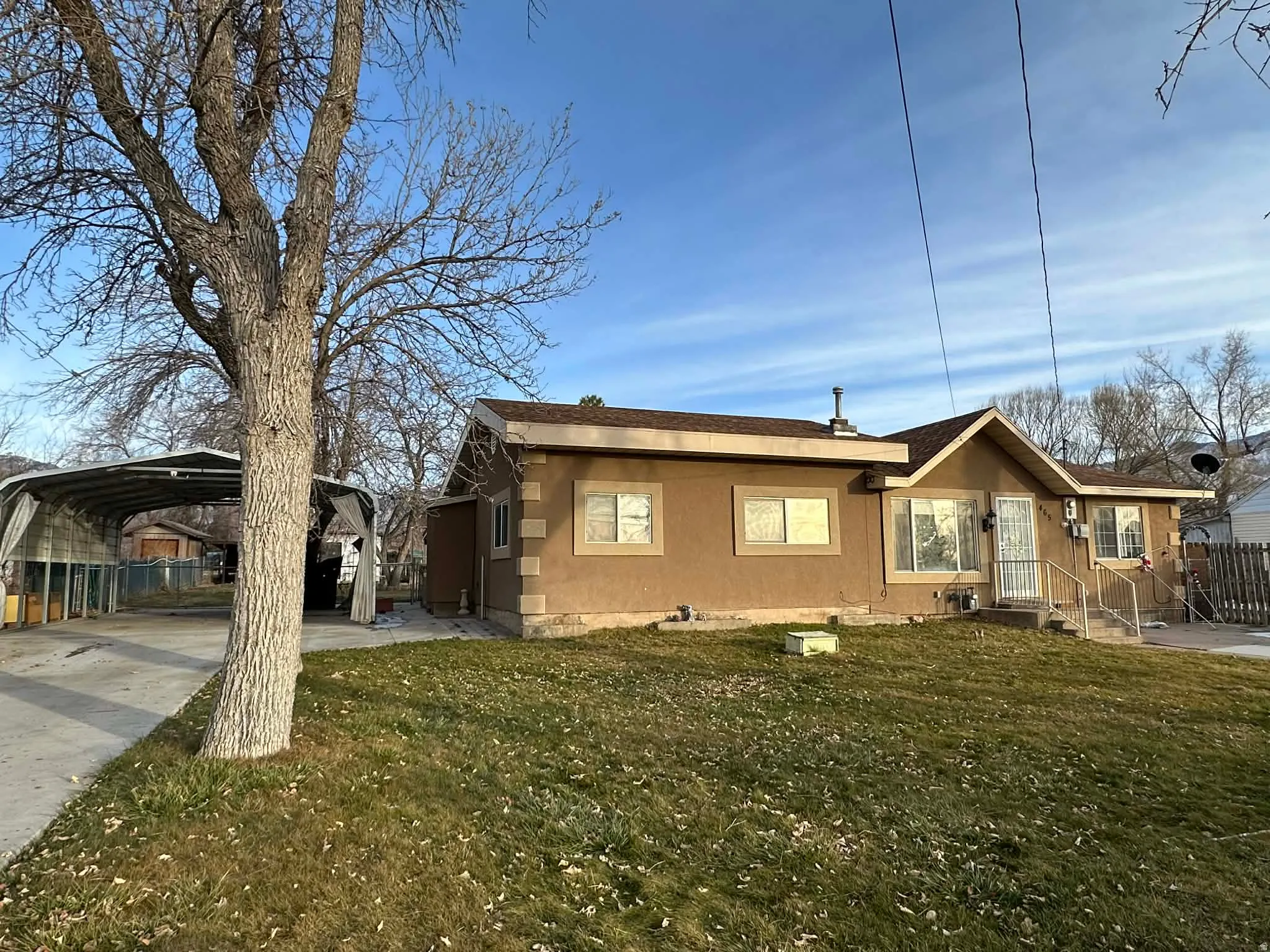 Bungalow-style house with a carport and concrete driveway