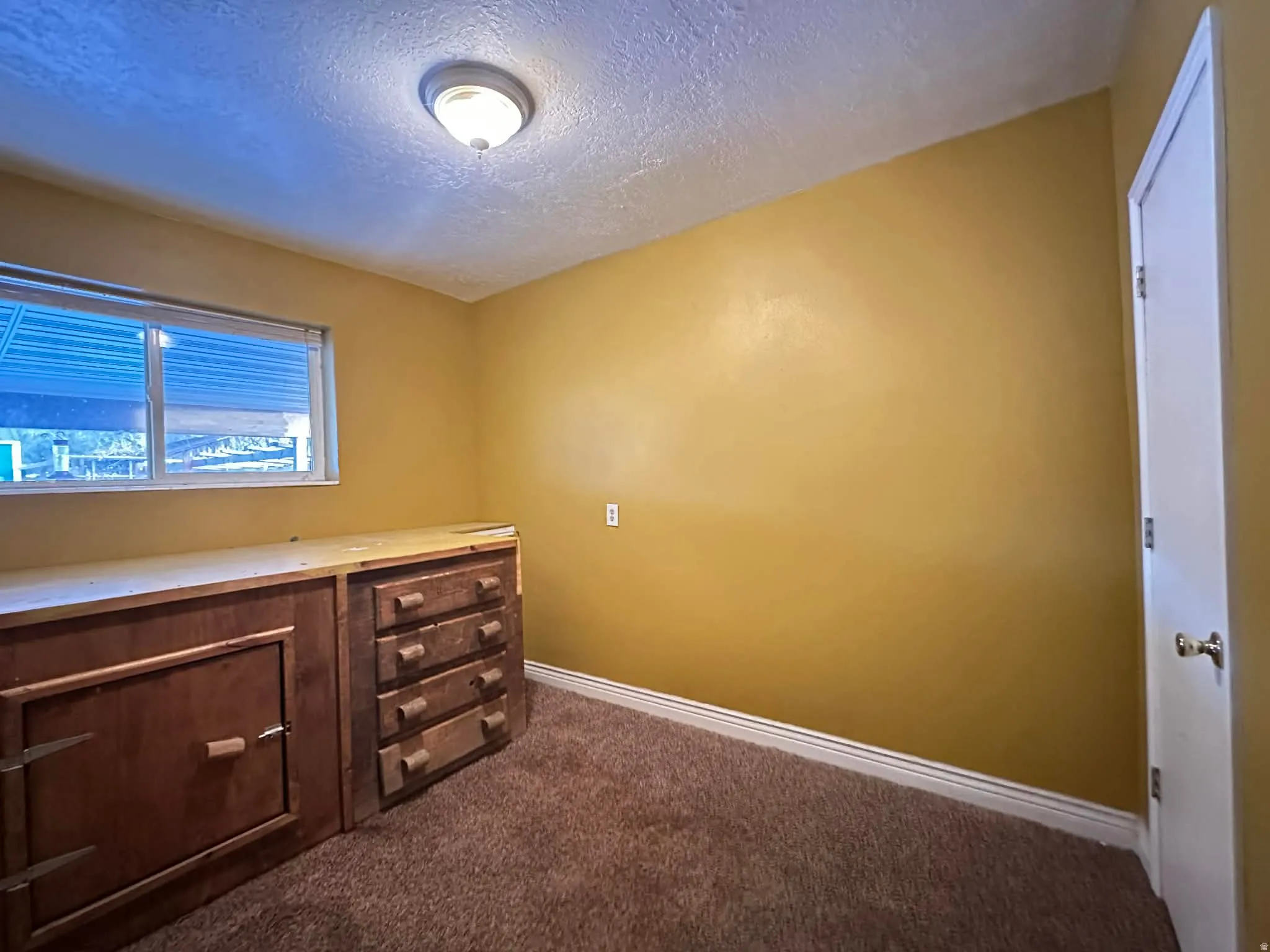 This room can be used as a bedroom or office. The cabinet is built in. The prior owner used it as a platform bed.