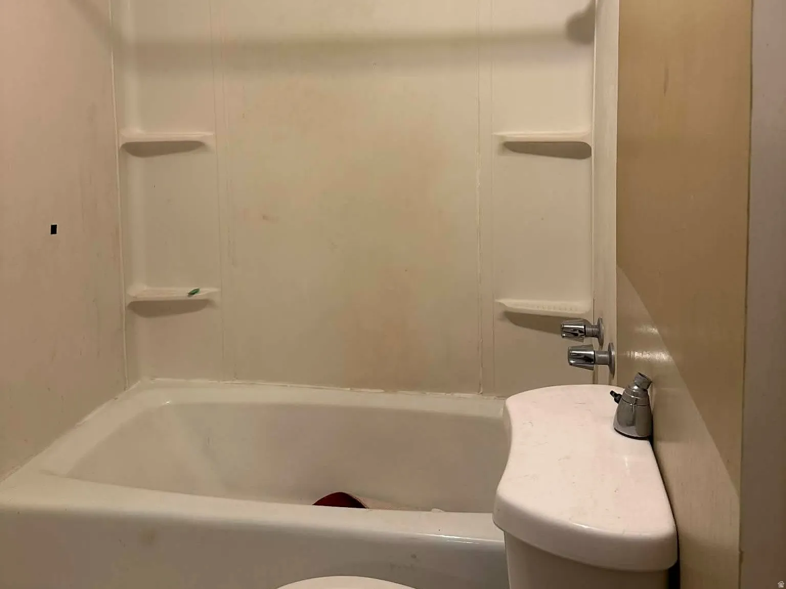 Bathroom featuring shower / tub combination and a textured ceiling