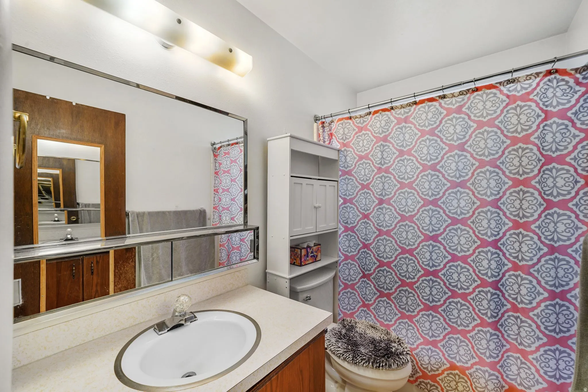 Bathroom featuring curtained shower and vanity