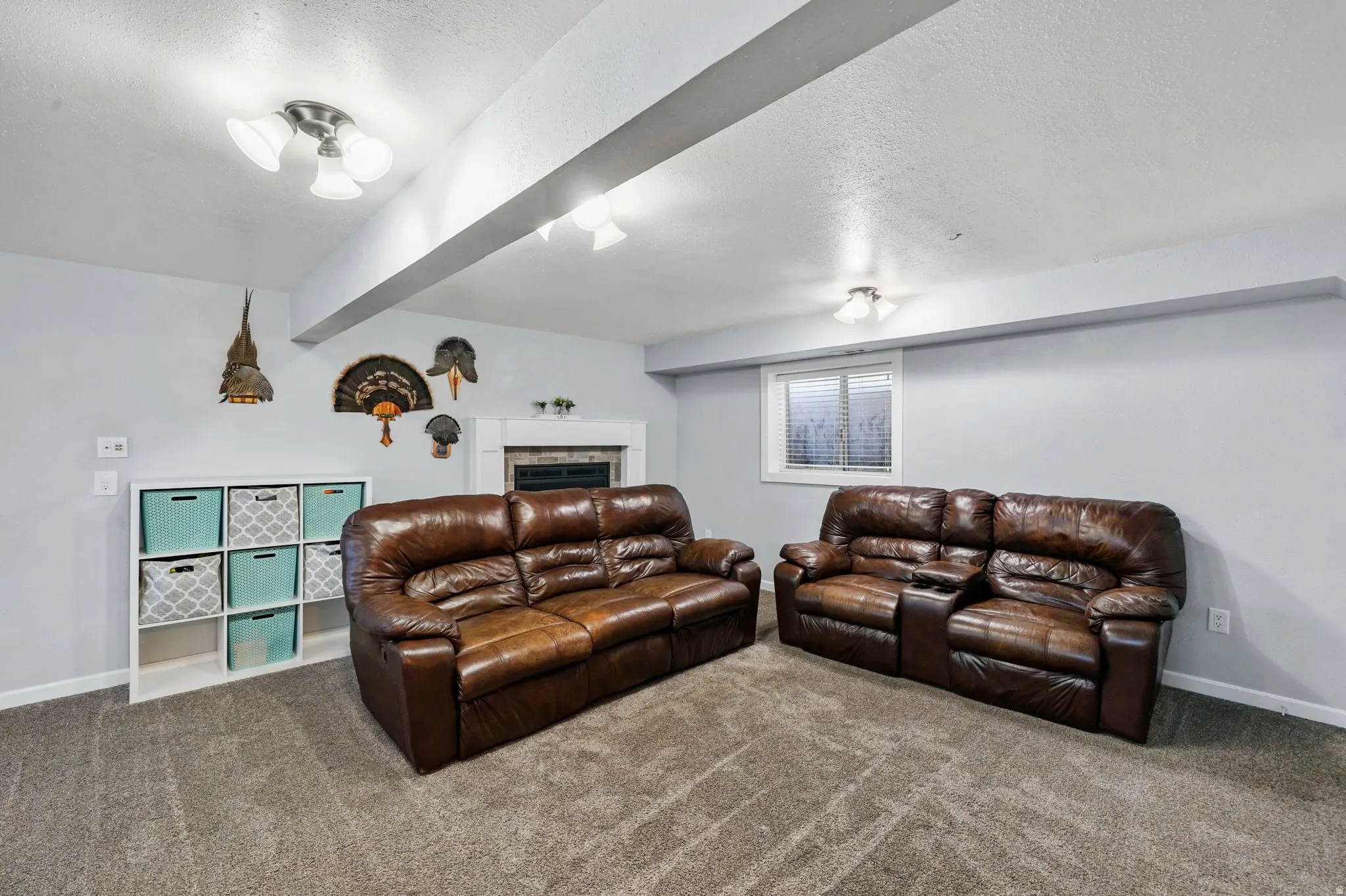 Carpeted living area featuring a textured ceiling