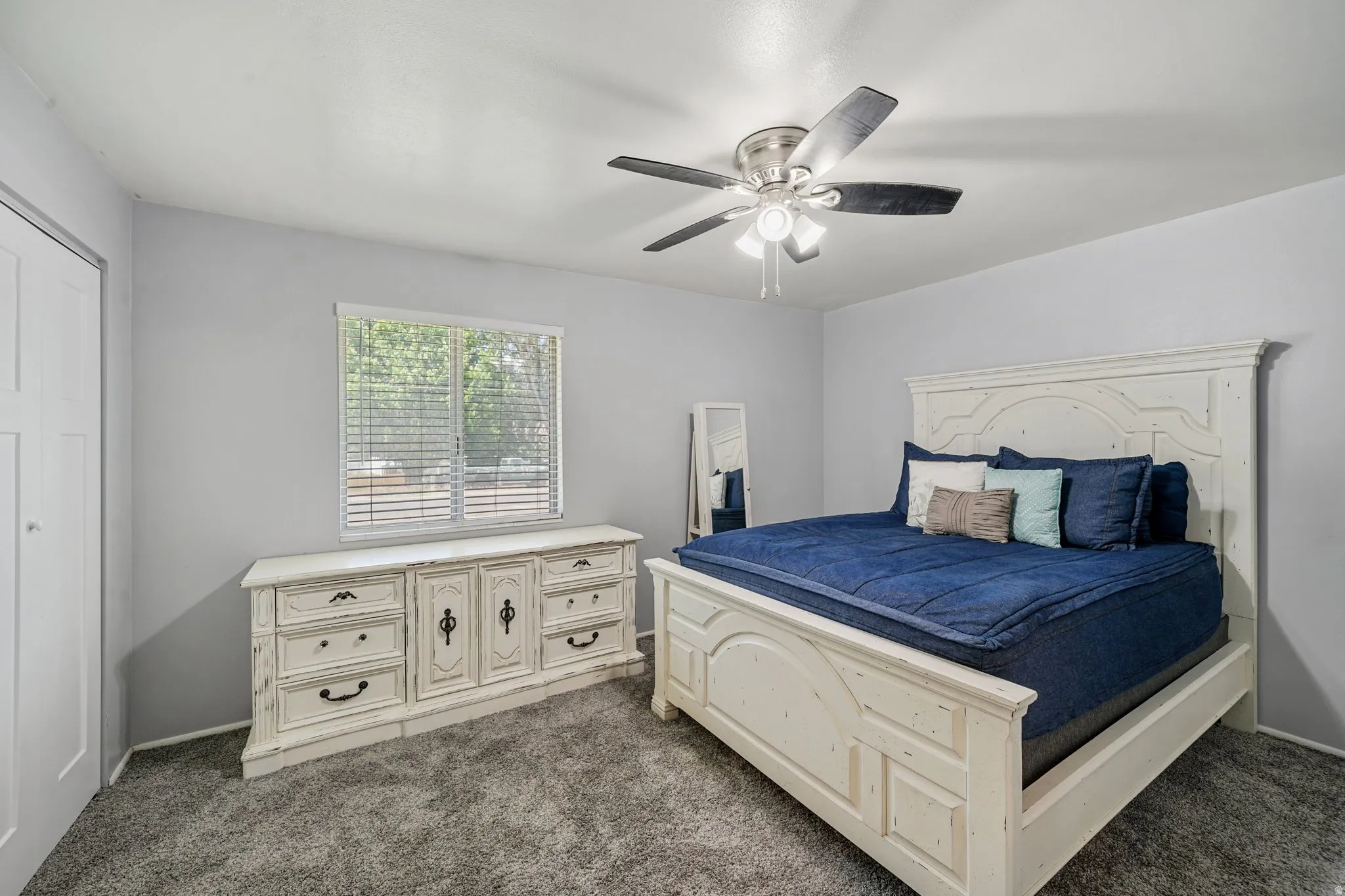 Bedroom featuring dark colored carpet and a ceiling fan