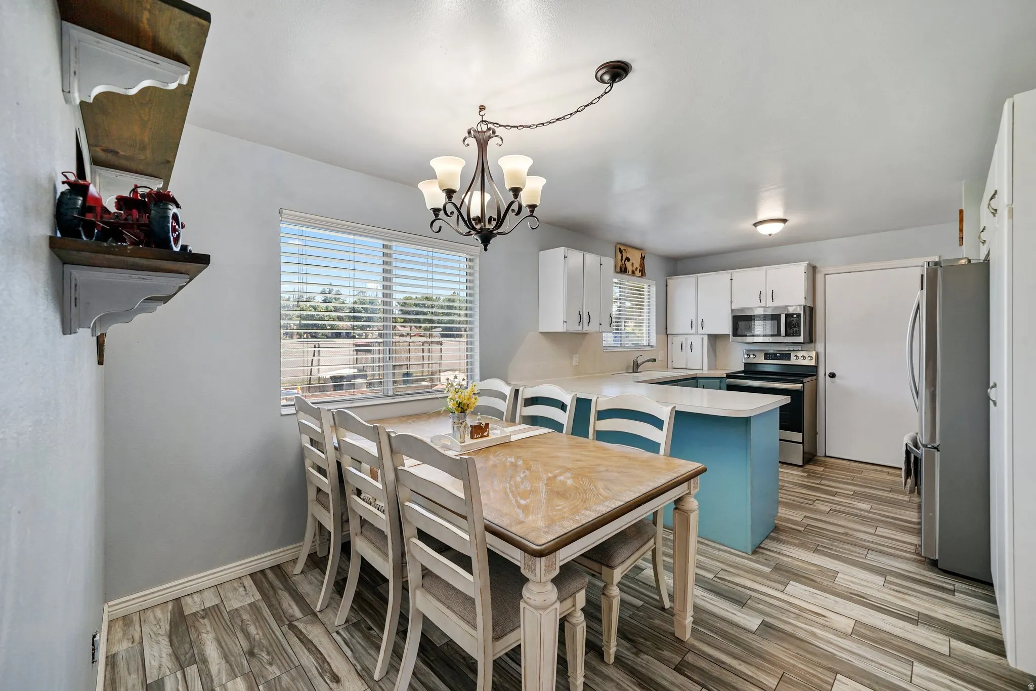 Dining room featuring light wood-style flooring, plenty of natural light, and a chandelier