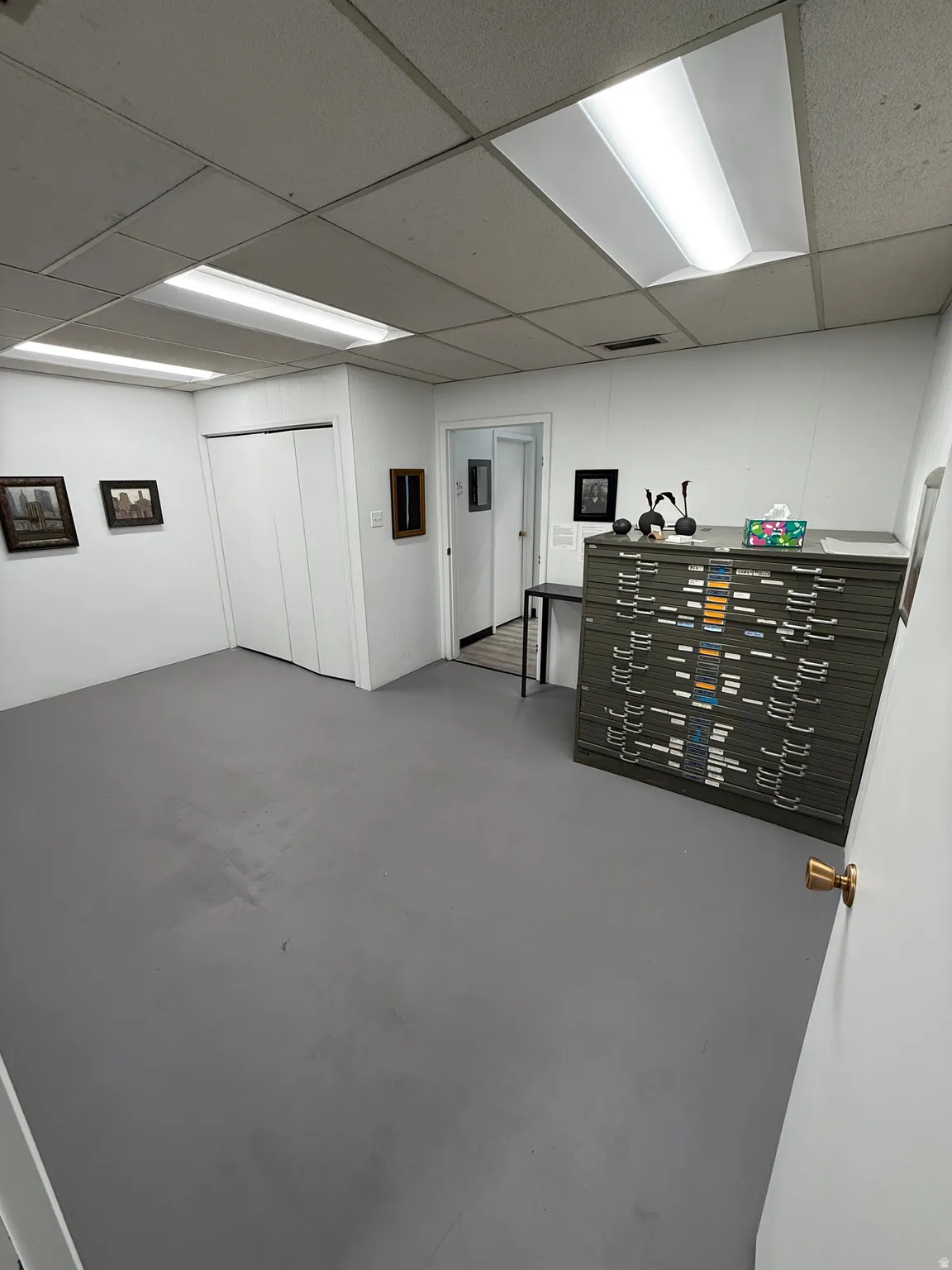 Finished basement featuring a paneled ceiling