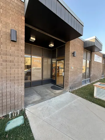 View of exterior entry featuring brick siding