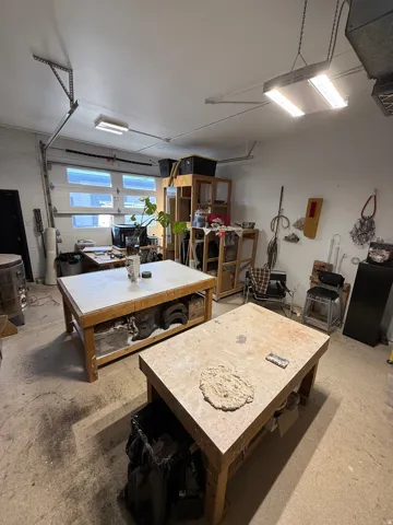 Dining space featuring a workshop area and concrete flooring