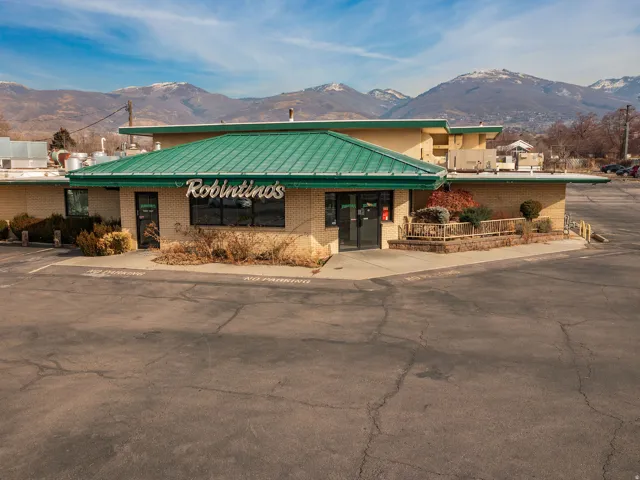 View of commercial property featuring a mountain view