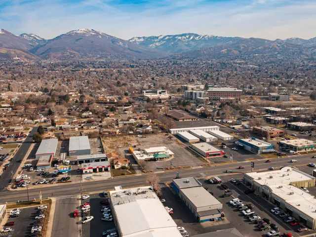 Aerial view of property and surrounding area featuring mountains