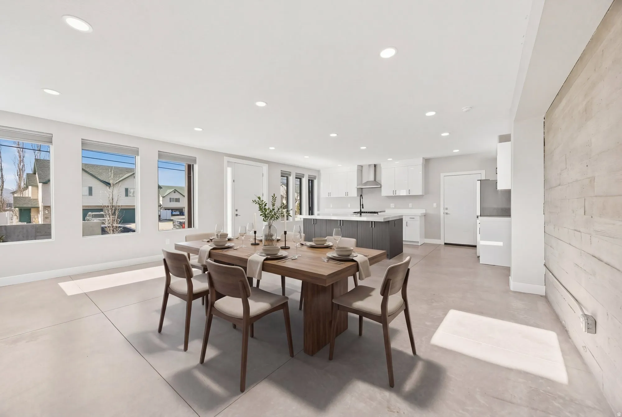 Dining space with concrete floors and recessed lighting