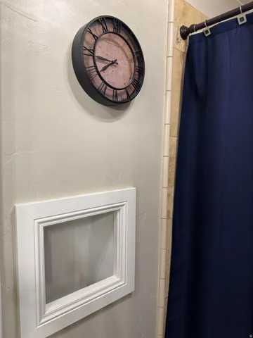 Bathroom view of a shower with shower curtain