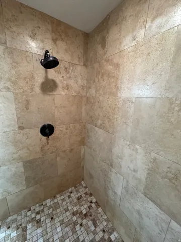 Bathroom view of a tile shower