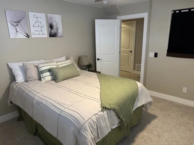 Carpeted bedroom with baseboards