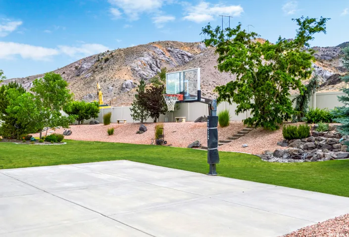 View of basketball court with a mountain view and basketball hoop