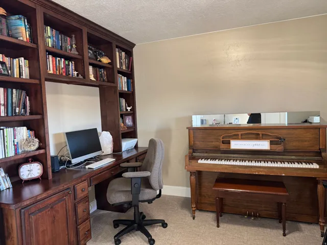 Office area with a textured ceiling and baseboards