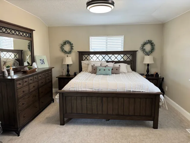 Bedroom featuring light colored carpet