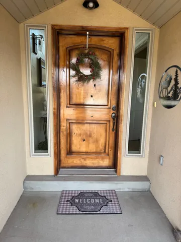 Doorway to property featuring stucco siding