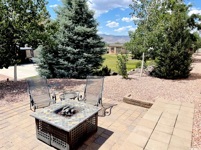 View of patio / terrace featuring a fire pit and a mountain view