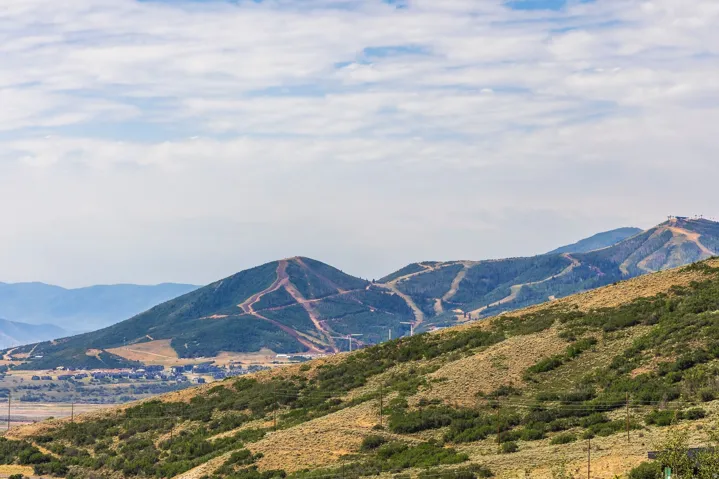 Additional contentThis image is a landscape/scenic photograph showing distant hillsides, vegetation, and sky