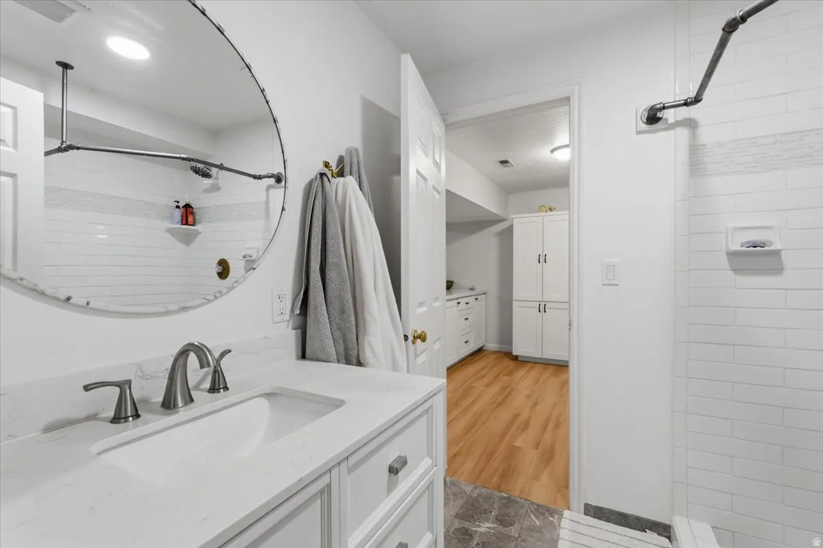 Full bathroom with tiled shower and vanity