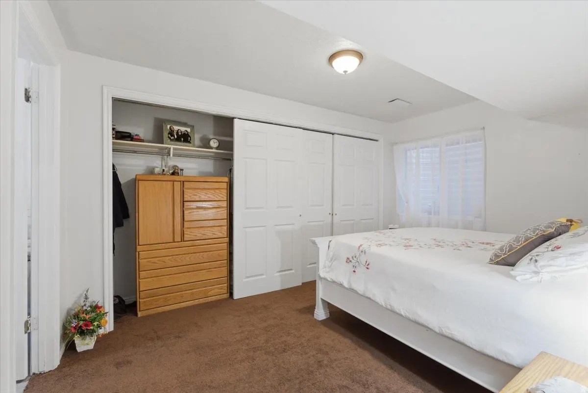 Bedroom featuring a closet and dark carpet