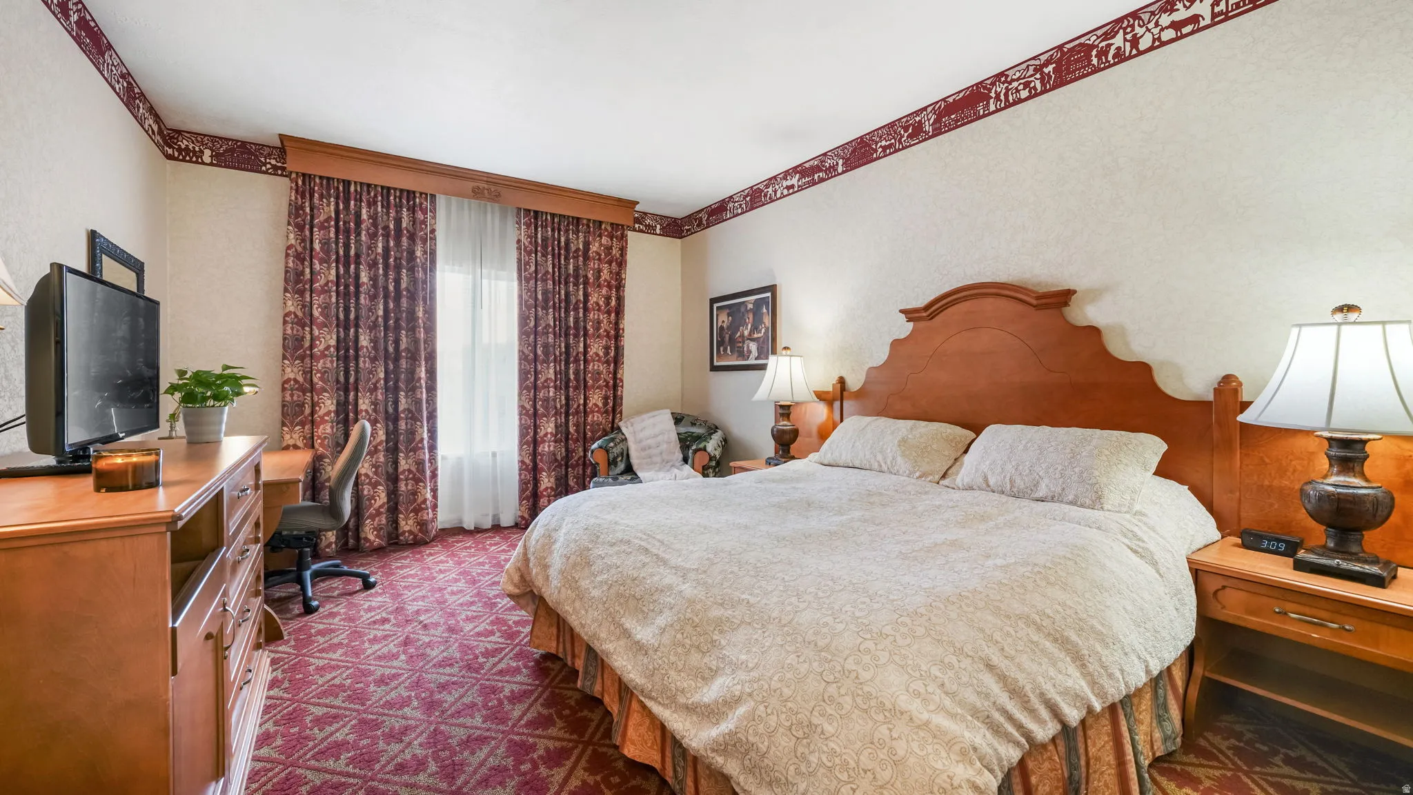Carpeted bedroom featuring a desk