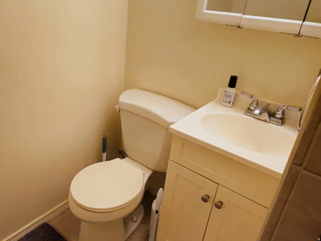 Half bathroom featuring vanity and toilet