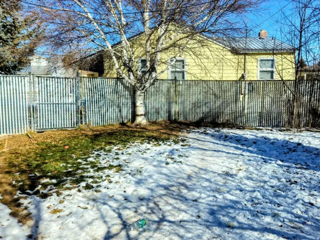 View of snowy exterior featuring a chimney