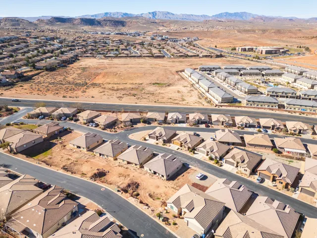 Aerial overview of property's location with nearby suburban area and a mountain backdrop