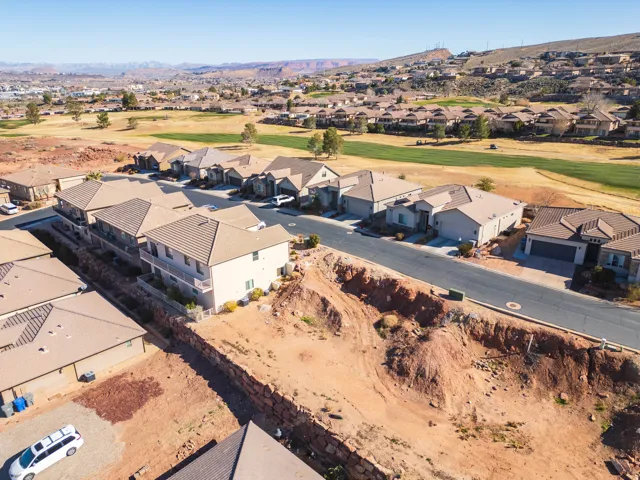 Aerial perspective of suburban area with a local golf course and mountains