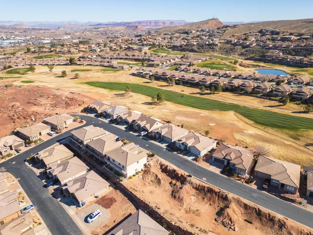 Aerial overview of property's location featuring nearby suburban area and a water and mountain view