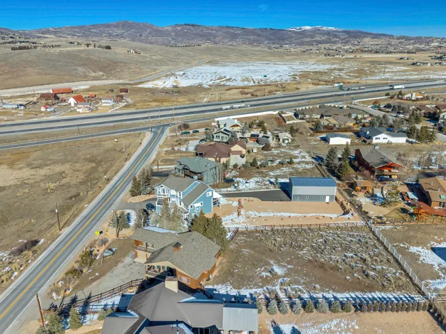 Snowy aerial view featuring a residential view and a mountain view