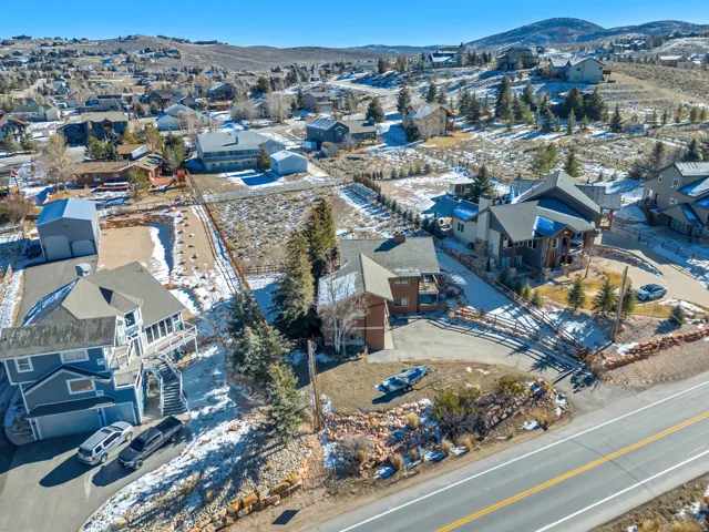 Snowy aerial view with a mountain view and a residential view