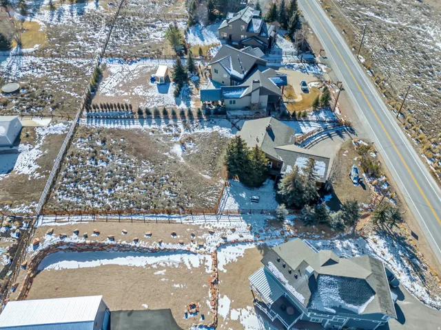 Snowy aerial view featuring a residential view