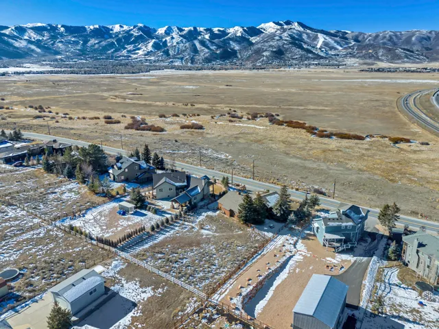 Snowy aerial view with a residential view and a mountain view