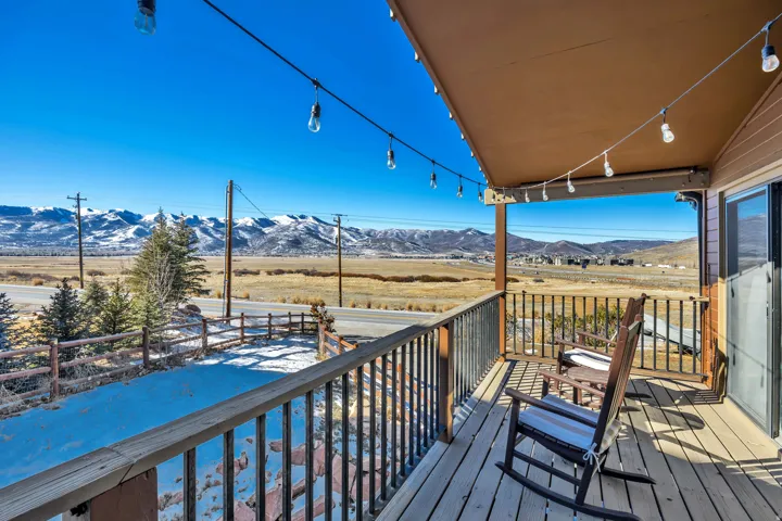 Deck with a mountain view and a view of countryside