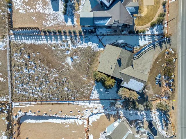 Snowy aerial view featuring a residential view