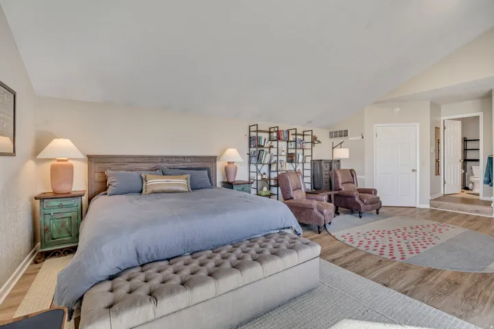 Bedroom with vaulted ceiling and wood finished floors
