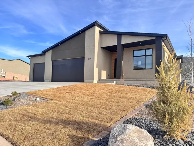 Contemporary home featuring stucco siding, driveway, an attached garage, a front yard, and a porch