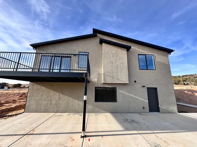 Rear view of property with stucco siding and a patio area