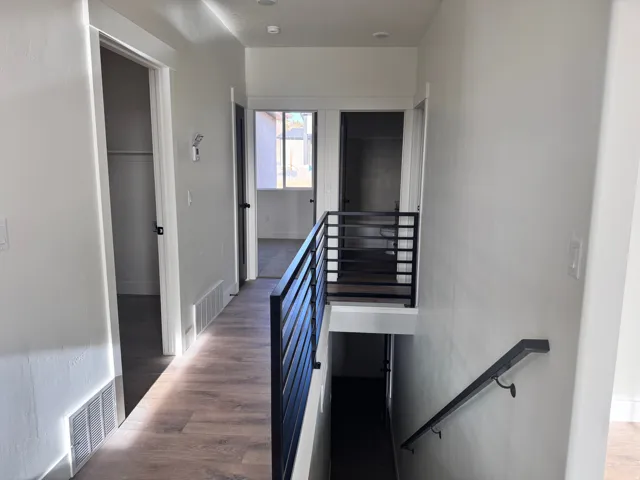Stairs with wood finished floors and baseboards