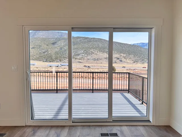 Entryway featuring a mountain view, healthy amount of natural light, and wood finished floors