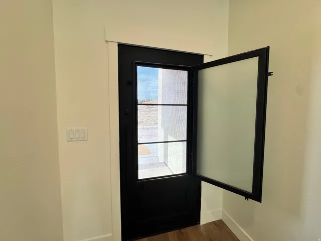 Entryway with wood finished floors and baseboards