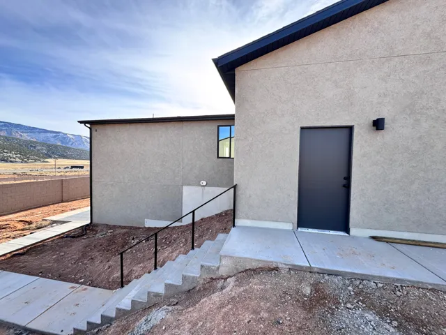 Doorway to property featuring stucco siding and a mountain view