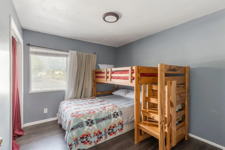 Bedroom featuring wood finished floors and baseboards